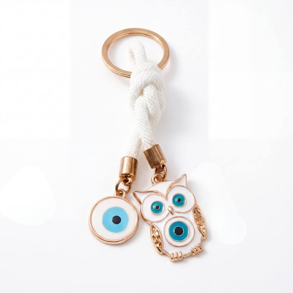Dos llaveros de ojo turco blancos con argollas doradas
