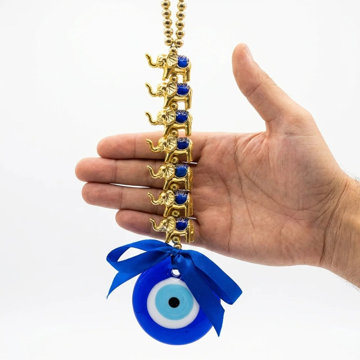 Amuleto de elefantes con cadena dorada sostenido en la mano